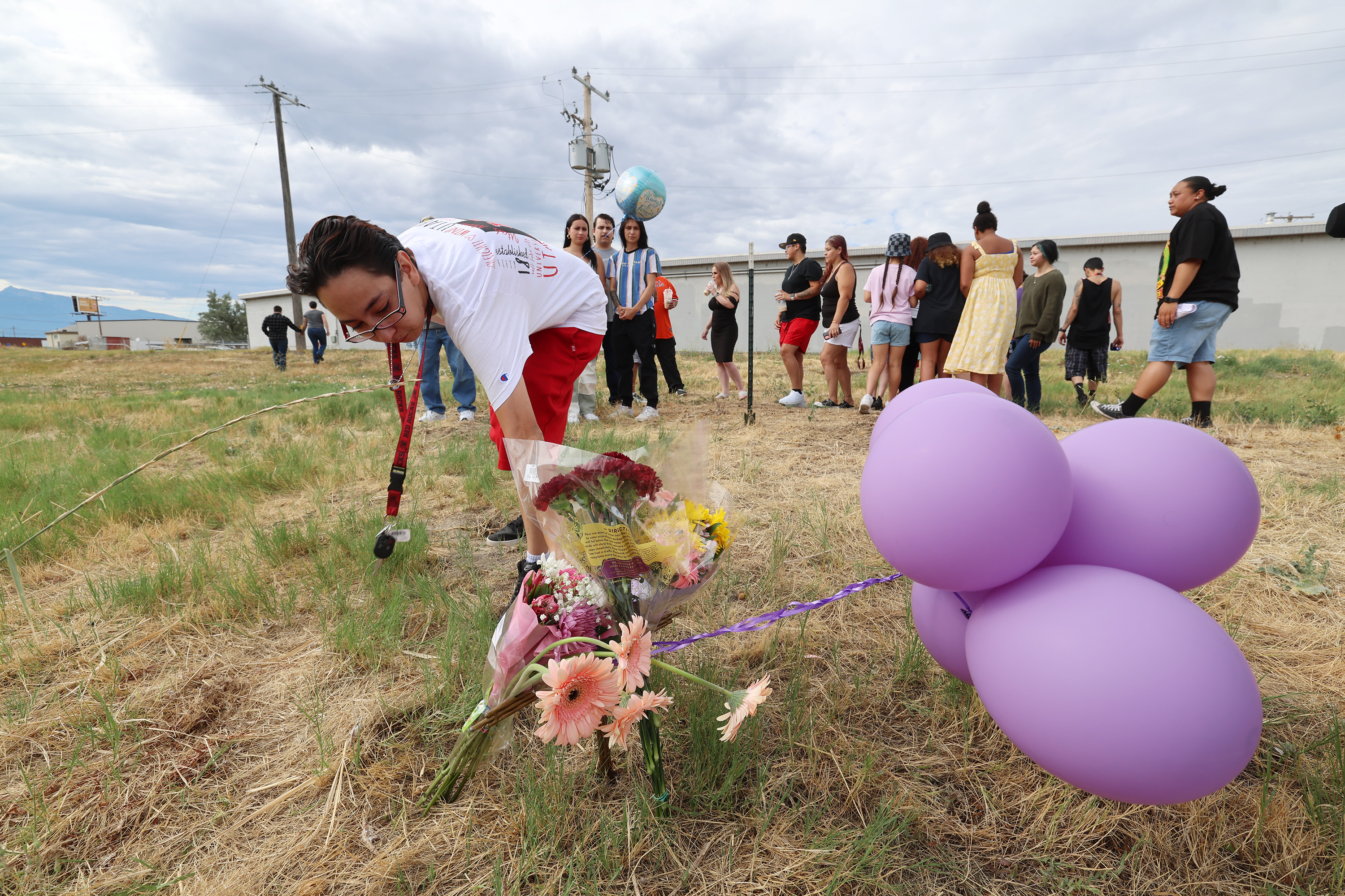 Angelica Tapia, a sister of Rosie, touches a small marker that the family placed after private investigator Jason K. Jensen, announced an increase in the reward for information in the murder case of Rosie Tapia on Saturday. The reward is now $100,000. The family came out to the place Rosie’s body was found 27 years ago along the Jordan River and California Avenue in Salt Lake City.