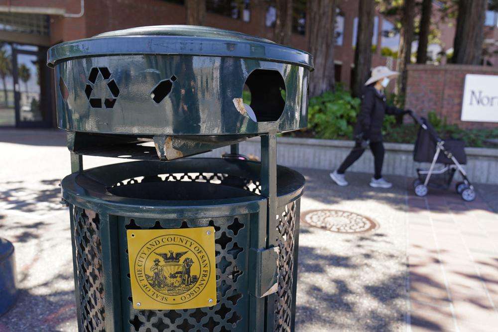 A woman walks past a Renaissance trash can that has been used for nearly 20 years in San Francisco, on July 26. As a replacement for the Renaissance trash can, city officials have deployed custom-made trash cans that took more than 3 years to design and produce, including one prototype that cost taxpayers more than $20,000. Now they are asking residents for feedback.