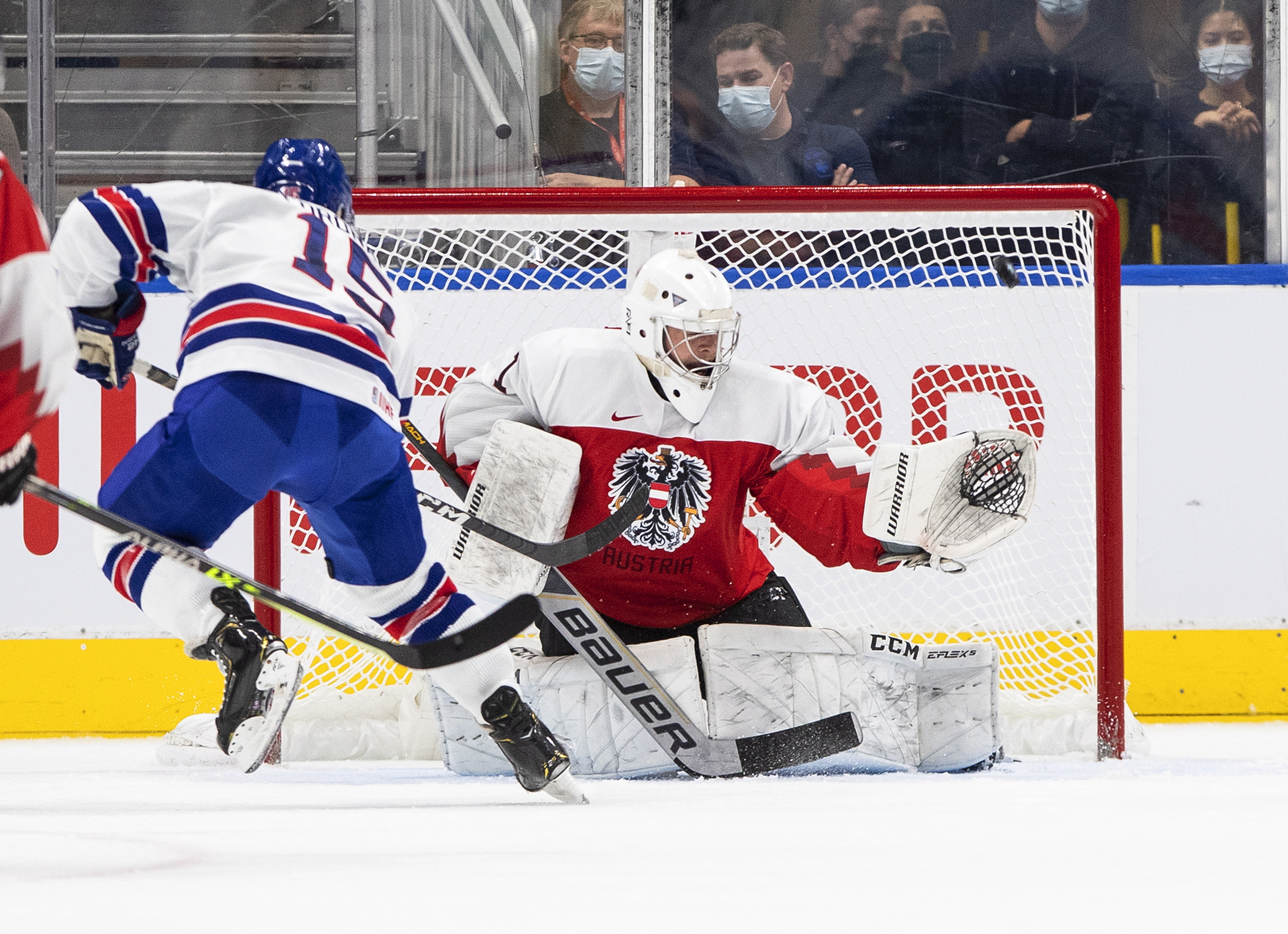 United States' Matthew Coronato (15) hits the post as Austria's goalie Leon Sommer (1) tries to make a save during the first period of an IIHF World Junior Hockey Championship game in Edmonton, Alberta, Saturday, Aug. 13, 2022. 