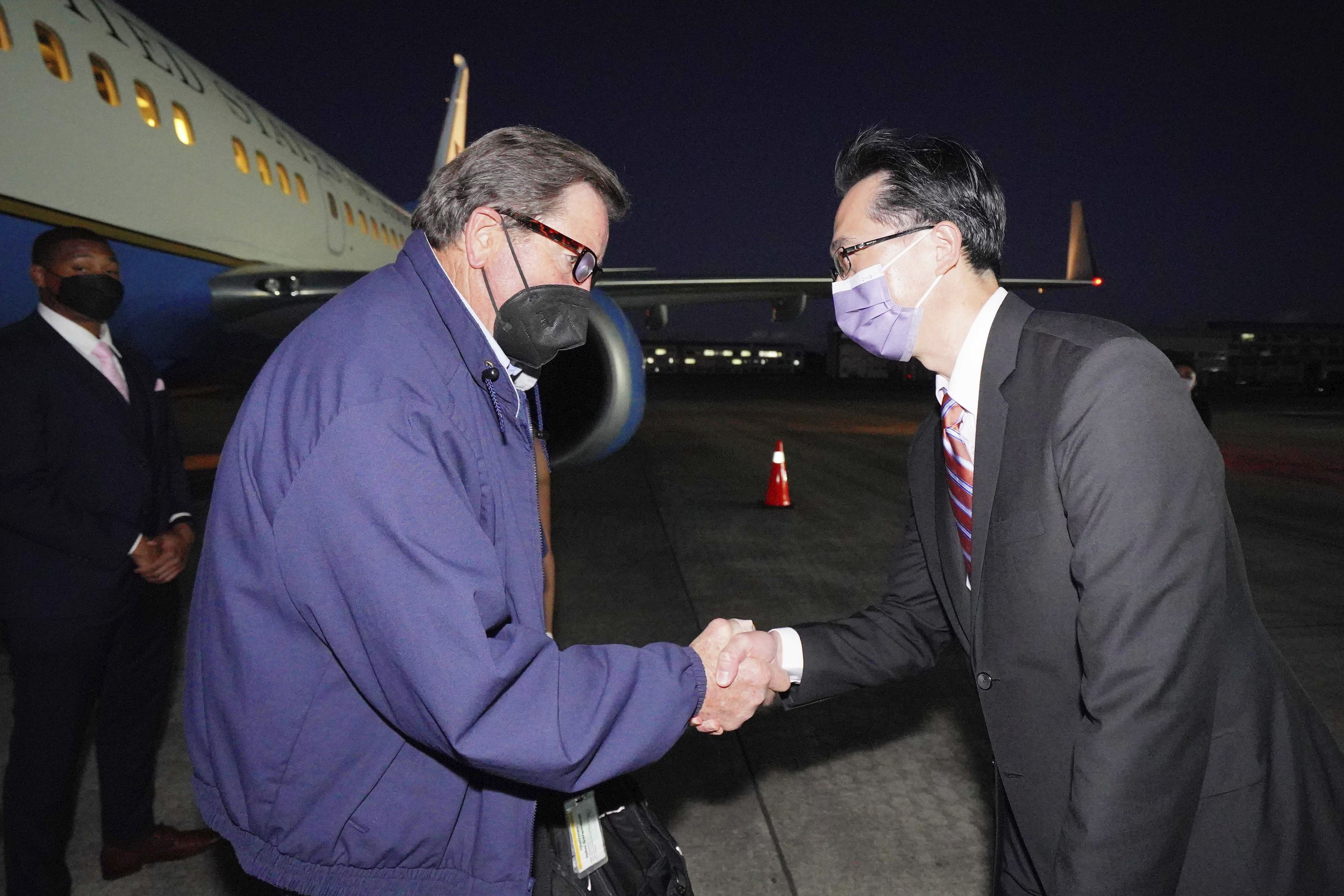 In this photo released by the Taiwan Ministry of Foreign Affairs, from left, U.S. Democratic House members John Garamendi shakes hands with Donald Yu-Tien Hsu, Director-General, dept. of North American Affairs, Taiwan's Ministry of Foreign Affairs after arriving on a U.S. government plane at Songshan airport in Taipei, Taiwan on Sunday. The delegation of American lawmakers are visiting Taiwan just 12 days after a visit by U.S. House Speaker Nancy Pelosi that angered China.