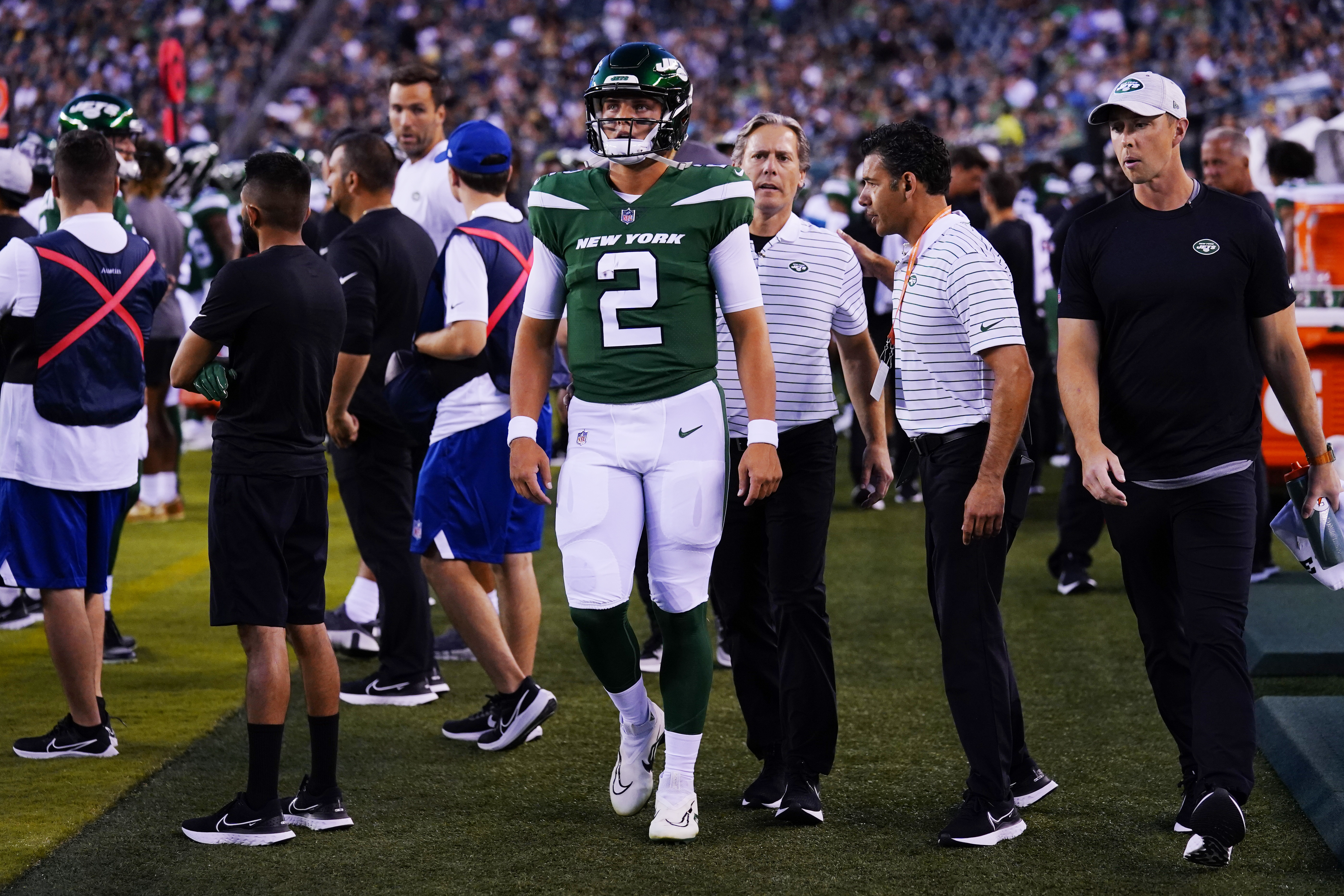 New York Jets' Zach Wilson walks on the sidelines after he is taken off the field following an injury during the first half of a preseason NFL football game against the Philadelphia Eagles on Friday, Aug. 12, 2022, in Philadelphia.