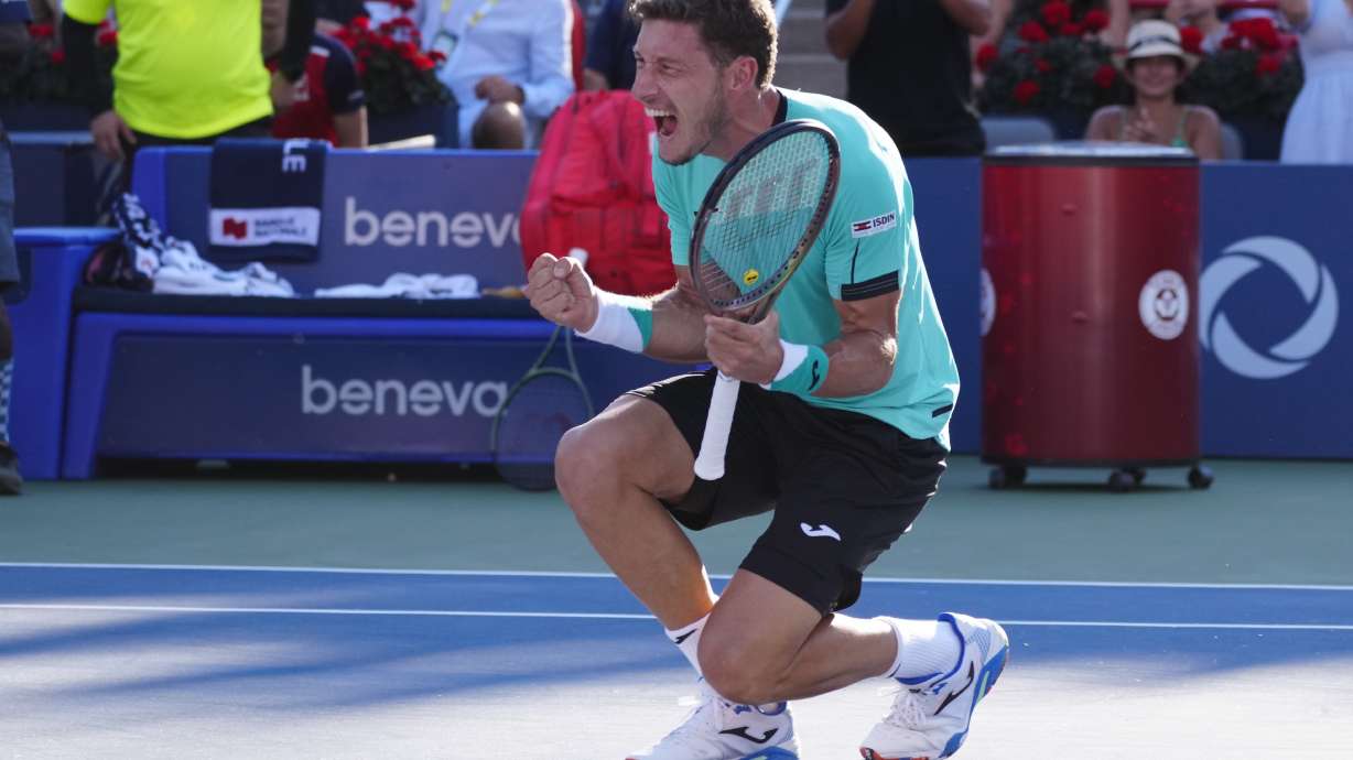 Pablo Carreno Busta, of Spain, reacts after defeating Hubert Hurkacz, of Poland, to win the final of the National Bank Open tennis tournament in Montreal, Sunday, Aug. 14, 2022.