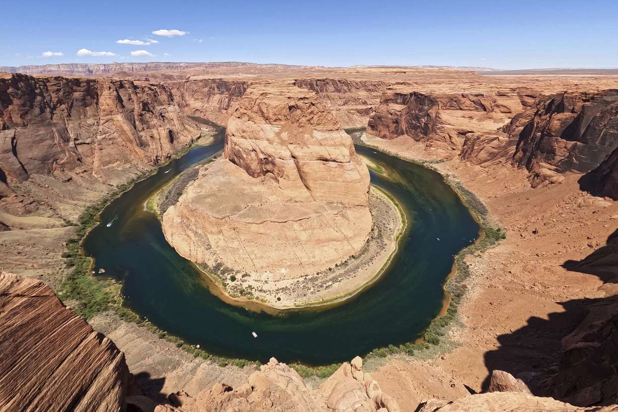 The Colorado River flows at Horseshoe Bend in the Glen Canyon National Recreation Area, June 8, 2022, in Page, Ariz. Seven states in the U.S. West are facing a deadline from the federal government to come up with a plan to use substantially less Colorado River water in 2023.