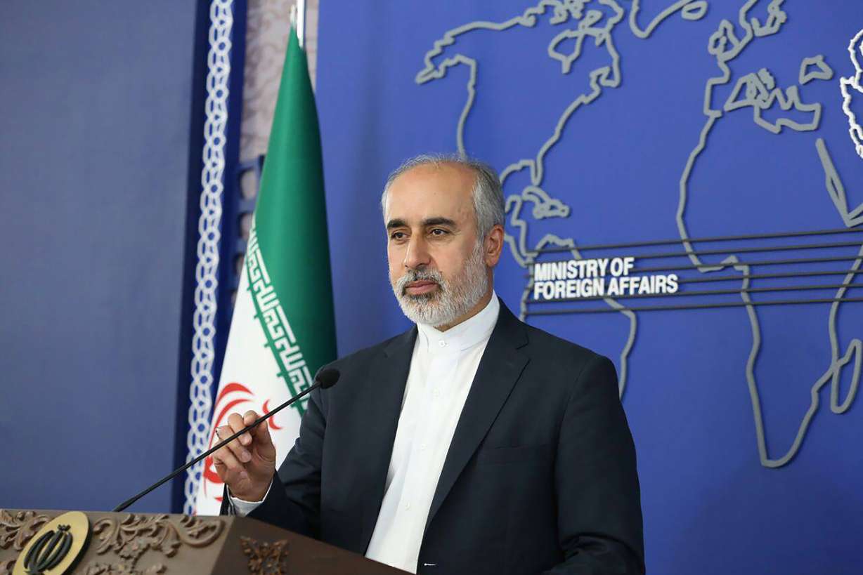 In this photo released on Thursday, by the Iranian Foreign Ministry, Foreign Ministry spokesperson Nasser Kanaani speaks in Tehran, Iran. Kanaani denied on Monday, that Tehran was involved in the assault on author Salman Rushdie, in remarks that were the country's first public comments on the attack.