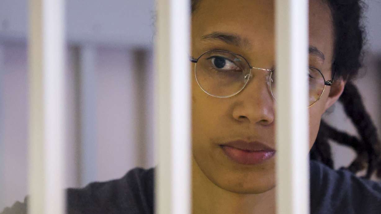 U.S. basketball player Brittney Griner looks through bars as she listens to the verdict in a courtroom in Khimki, outside Moscow, Russia, Aug. 4. Her lawyers on Monday filed an appeal of her nine-year Russian prison sentence for drugs possession.