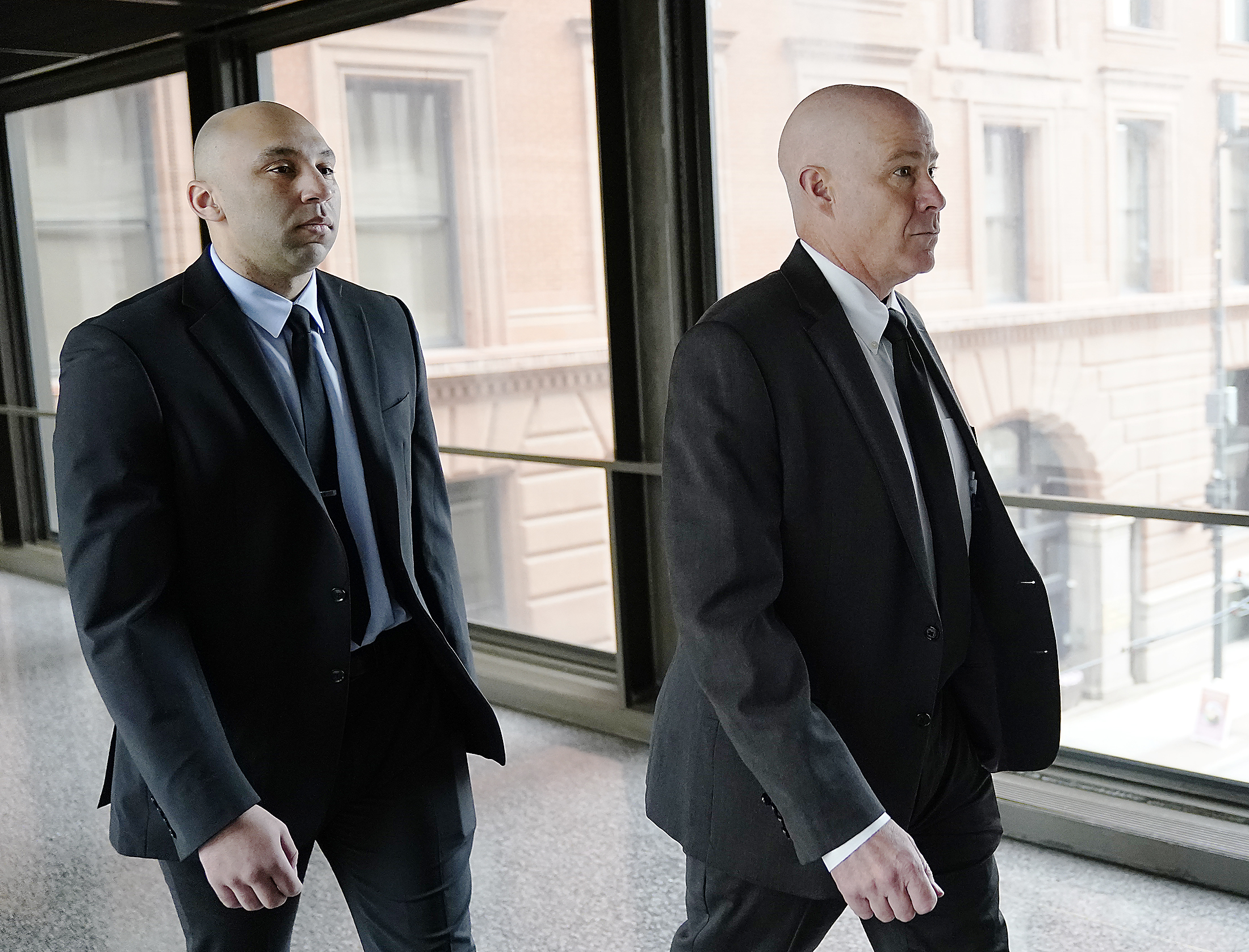Former Minneapolis police officer J. Alexander Kueng, left, and his attorney Thomas Plunkett arrive for sentencing July 27 in St. Paul, Minn.  Kueng and Tou Thao, both charged in George Floyd's killing, told a judge Monday that they have rejected plea deals that would have resulted in three-year prison sentences. 
