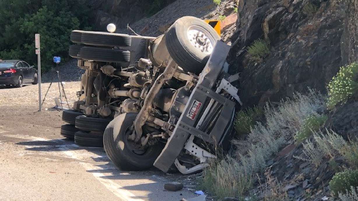 Police investigate following a fatal crash involving a vehicle and a dump truck along state Route 190 in Big Cottonwood Canyon on Aug. 15, 2022. The driver of a dump truck in a 2022 crash that killed a woman and her unborn baby was ordered to stand trial for manslaughter, but the judge ruled there was not evidence supporting charges for the truck's owner.