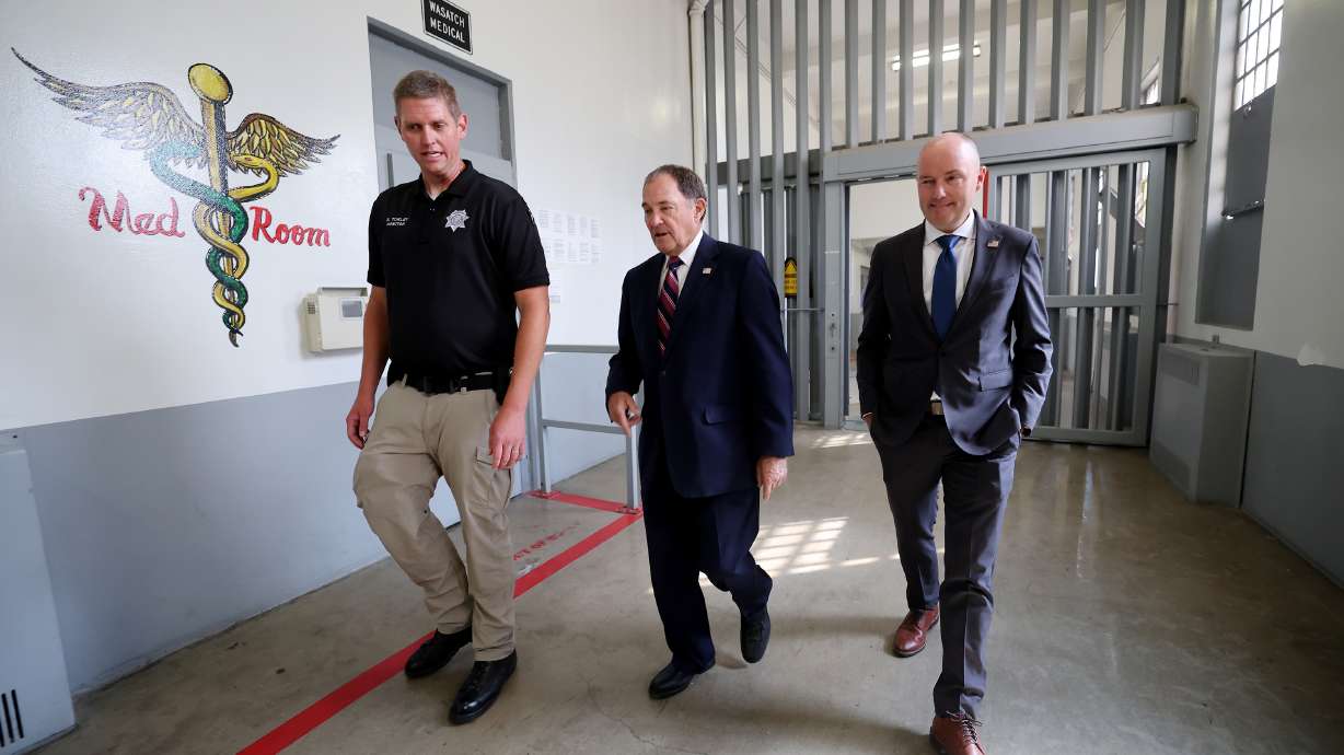Spencer Turley, director of prison operations for the Utah Department of Corrections, left, leads former Gov. Gary Herbert and Gov. Spencer Cox on a tour of the old Utah State Prison in Draper on Monday.