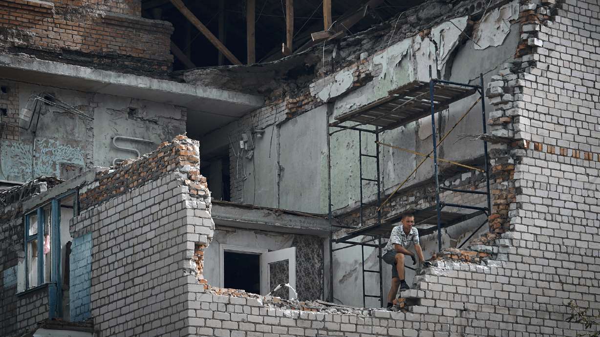 A man looks out from an apartment destroyed after Russian shelling in Nikopol, Ukraine, Monday.