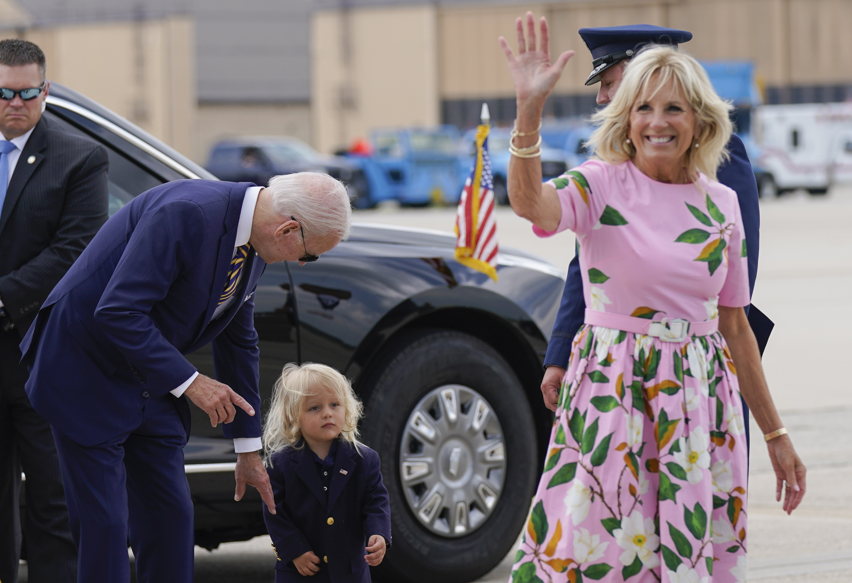 President Joe Biden looks at his grandson Beau Biden as first lady Jill Biden waves and walks to board Air Force One at Andrews Air Force Base, Md., Wednesday. First lady Jill Biden tested positive for COVID-19 and is experiencing "mild symptoms" the White House announced Tuesday. 
