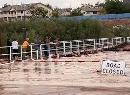 Short Creek floods onto a road in Hildale, Utah, Monday.