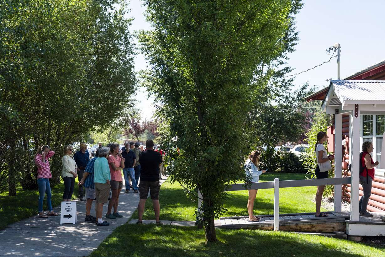 People wait in line to vote during the Republican primary election in Wilson, Wyo., Tuesday.