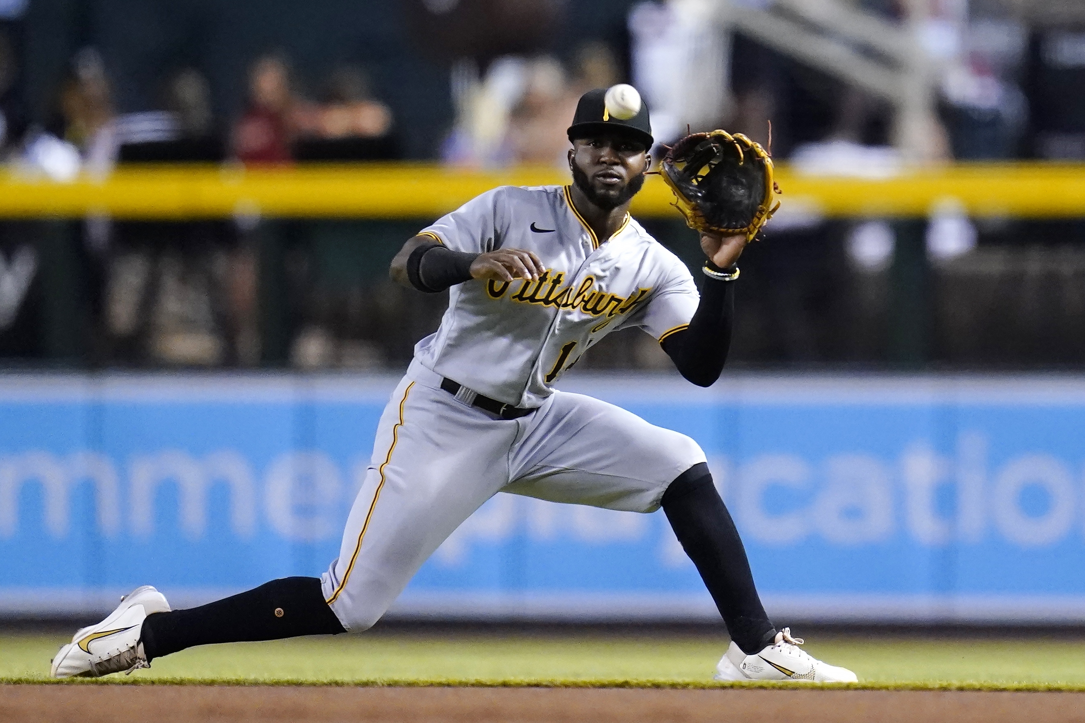 Pittsburgh Pirates second baseman Rodolfo Castro slides over to make a catch on a liner hit by Arizona Diamondbacks' Ketel Marte during the first inning of a baseball game Wednesday, Aug. 10, 2022, in Phoenix. 
