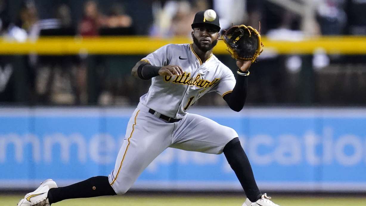 Pittsburgh Pirates second baseman Rodolfo Castro slides over to make a catch on a liner hit by Arizona Diamondbacks' Ketel Marte during the first inning of a baseball game Wednesday, Aug. 10, 2022, in Phoenix.
