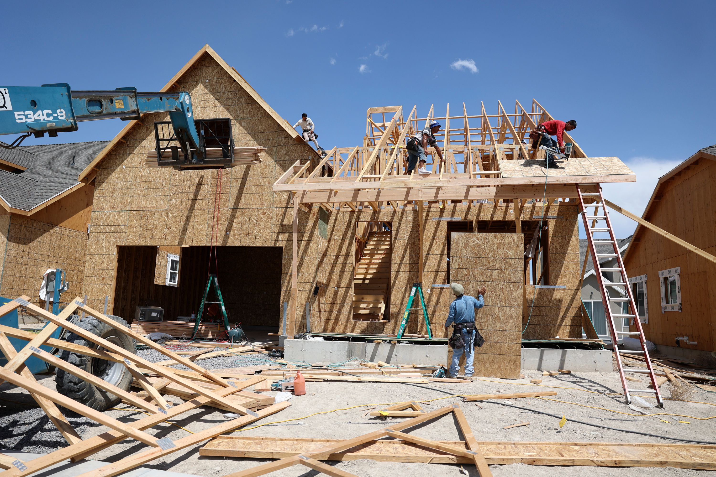 A construction crew builds a single-family home in the Overland community in Eagle Mountain on July 19. Home builder confidence has been taking a nosedive for eight straight months as the pandemic housing frenzy dies down yet supply chain issues continue, prompting some experts to warn the housing market correction is only beginning.