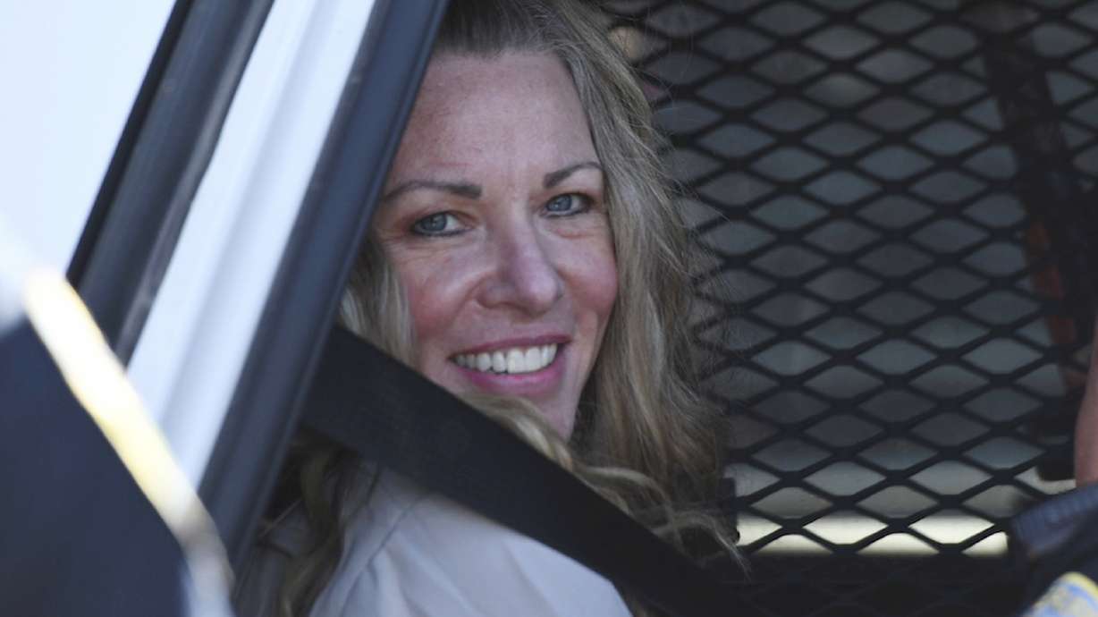 Lori Vallow Daybell sits in a police car after a hearing at the Fremont County Courthouse in Idaho, Aug. 16, 2022. She does not want to use a mental health defense during her trial even though her attorneys say she is mentally ill.