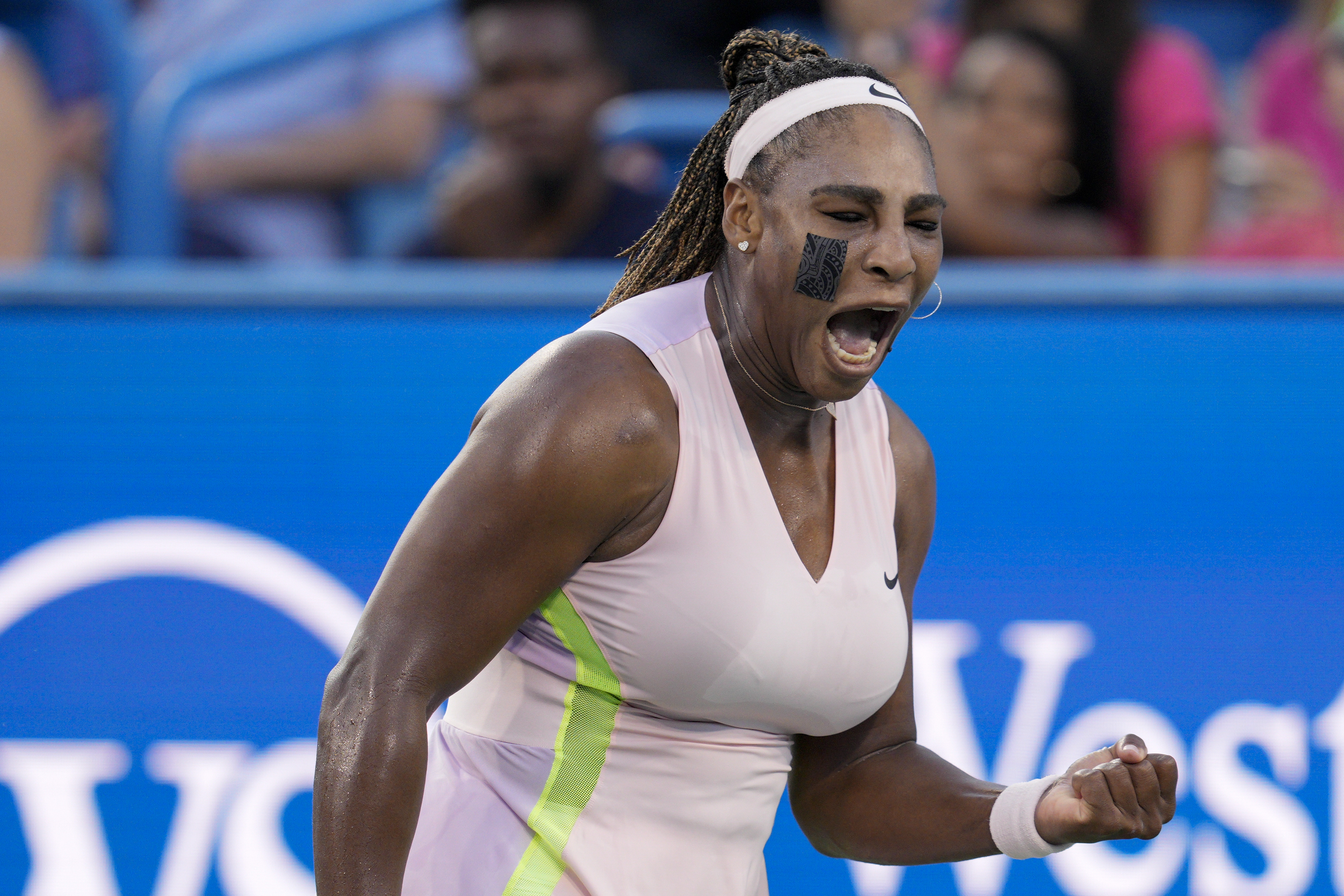 Serena Williams, of the United States, reacts after winning a point against Emma Raducanu, of Britain, during the Western & Southern Open tennis tournament Tuesday, Aug. 16, 2022, in Mason, Ohio. 