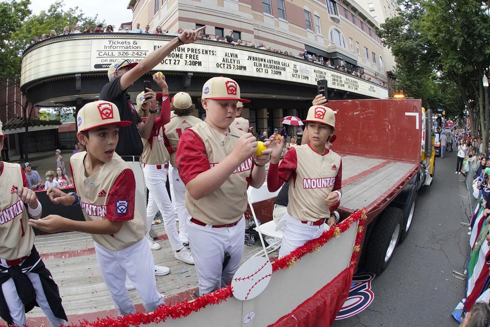 The Mountain Region champion Little League team from Santa Clara, Utah, rides in the Little League Grand Slam Parade in downtown Williamsport, Pa., Monday.  A 12-year-old Little League World Series player from Utah was in critical condition Tuesday with what his family said was a head injury.