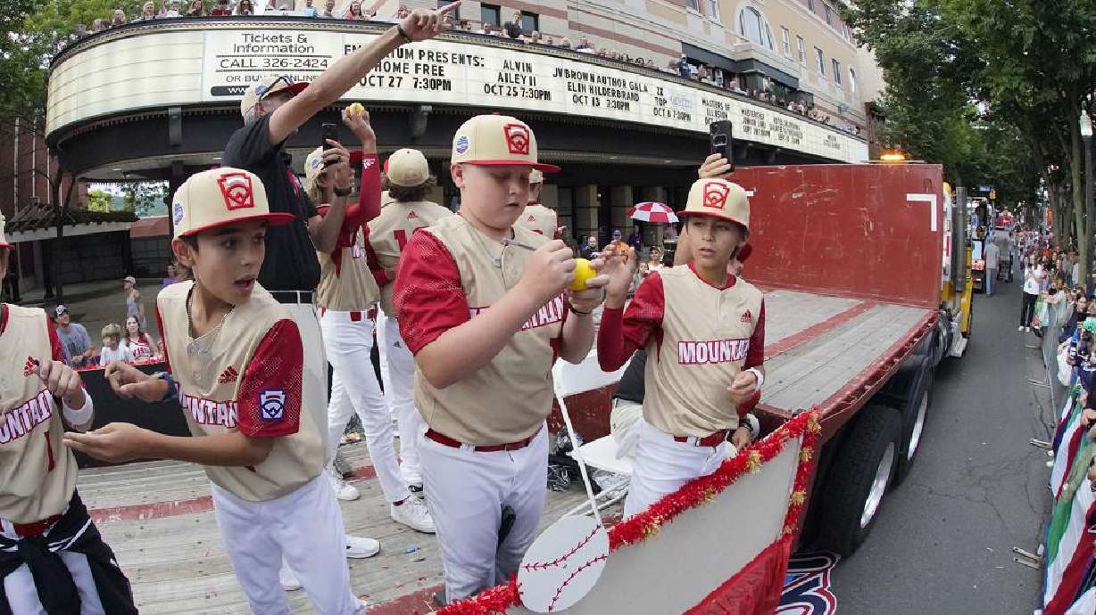The Mountain Region champion Little League team from Santa Clara, Utah, rides in the Little League Grand Slam Parade in downtown Williamsport, Pa., Monday. A 12-year-old Little League World Series player from Utah was in critical condition Tuesday with what his family said was a head injury.