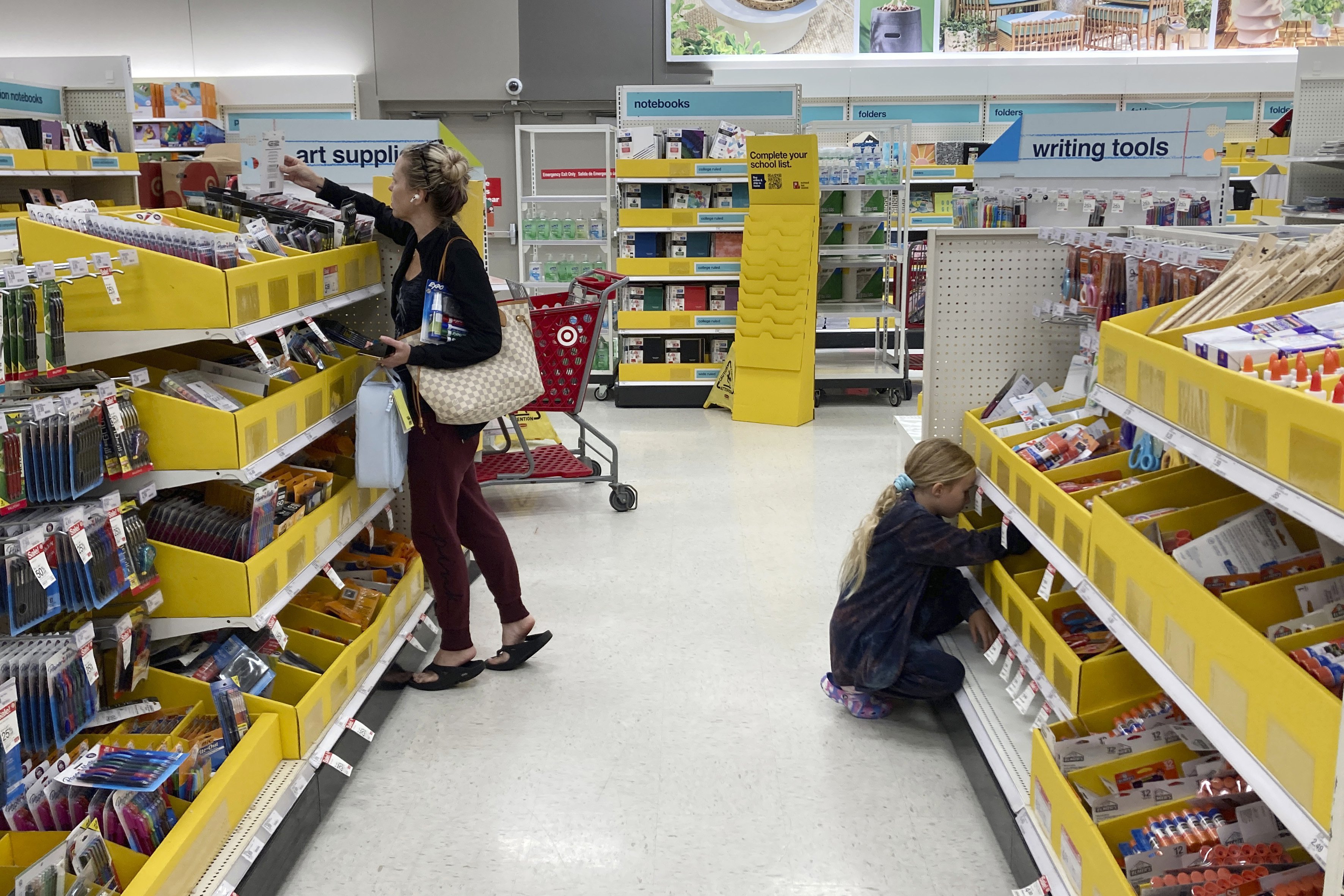 A parent shops for school supplies deals at a Target store July 27 in North Miami, Fla. Target reported Wednesday solid sales for the fiscal second quarter but its profits plunged nearly 90% because it slashed prices to clear unwanted inventories.