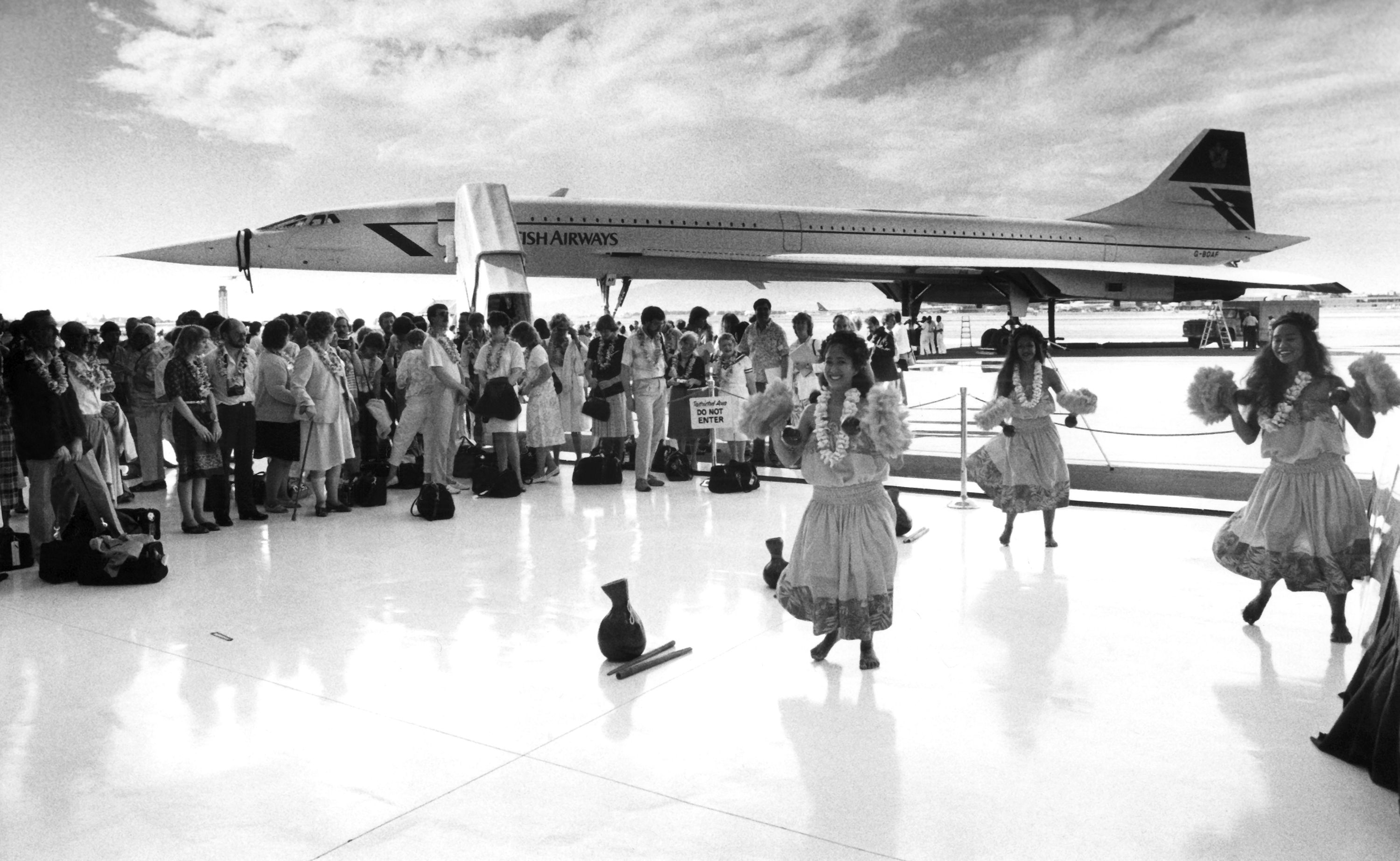 Hawaiian hula dancers perform to greet passengers aboard a British Airways Concorde jet that arrived at Honolulu, Tuesday, Nov. 13, 1986, as part of a round-the-world trip. It was the first landing in Hawaii by a supersonic commercial jet.