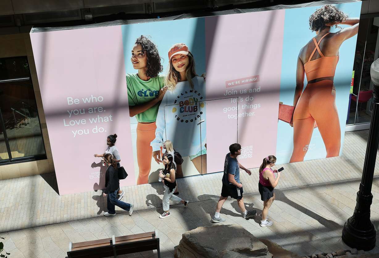 Shoppers walk through City Creek Center in Salt Lake City on Wednesday. A Census Bureau report shows U.S. consumer spending continues to run at record volume in spite of persistent, record-high inflation.