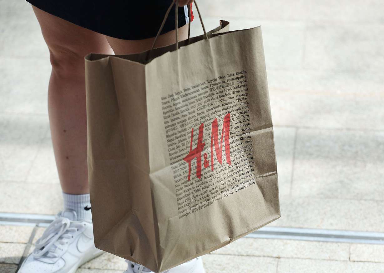 A shopper carries her package at City Creek Center in Salt Lake City on Wednesday. A Census Bureau report shows U.S. consumer spending continues to run at record volume in spite of persistent, record-high inflation.