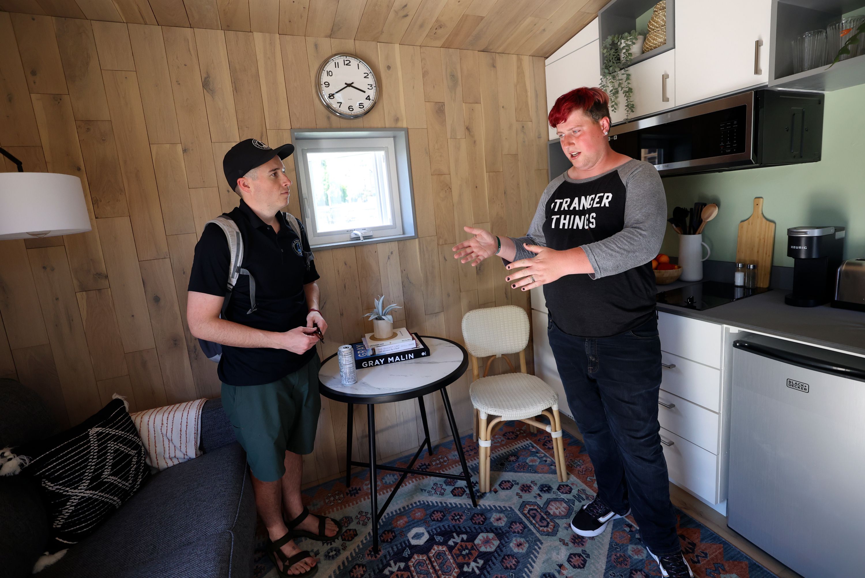 Tanya Takoda Peatross, a sophomore neighbor at The Other Side Village, right, envisions her sisters sleeping on a pull-out couch when they visit her future home, as she talks to Samuel Grenny, The Other Side Village director of communications, in a 280-square-foot cottage that will be part of The Other Side Village, providing affordable, permanent housing for people coming out of chronic homelessness, like Peatross, in Salt Lake City on Wednesday.
