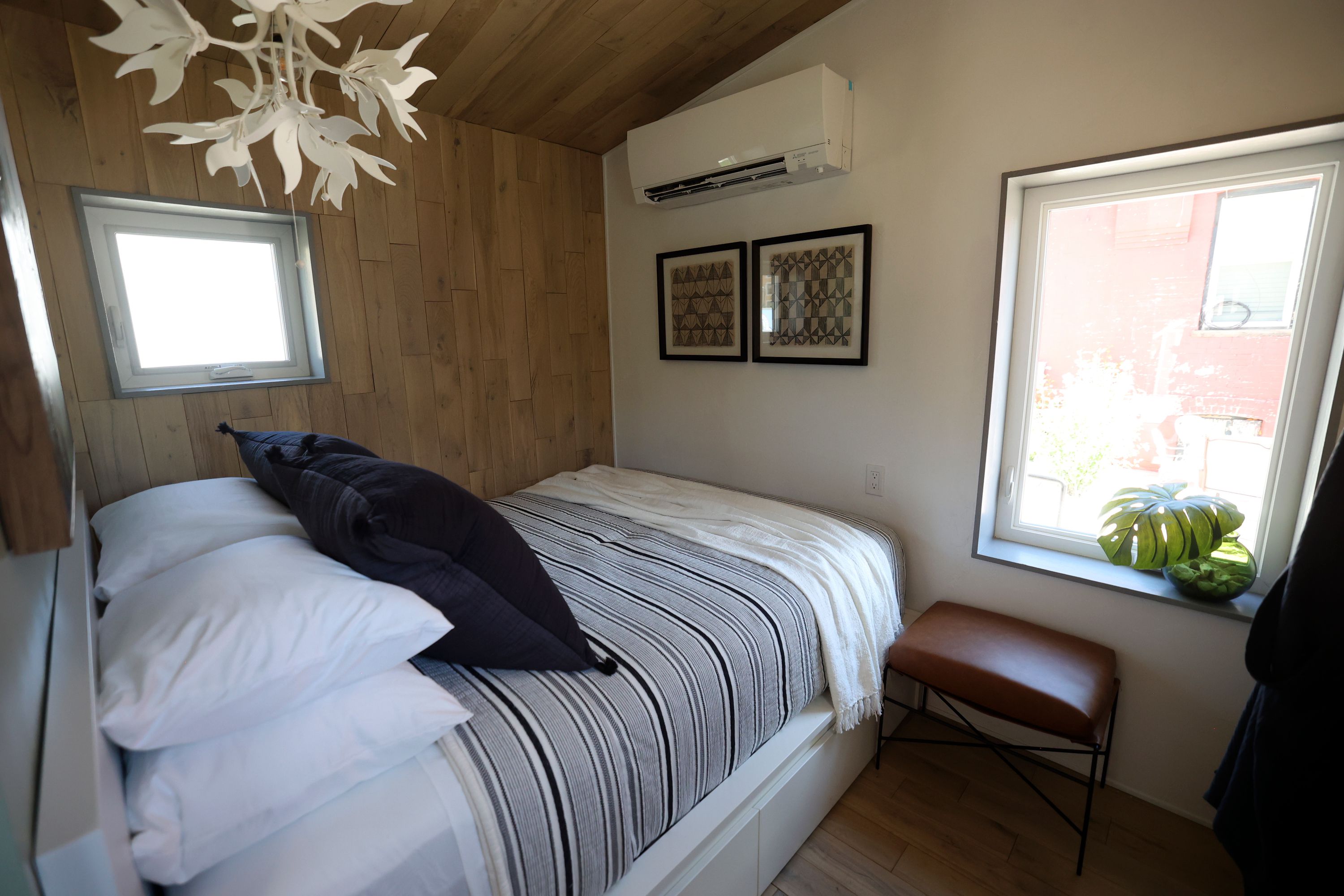 The bedroom is pictured in a 280-square-foot cottage that will be part of The Other Side Village, providing affordable, permanent housing for people coming out of chronic homelessness, in Salt Lake City on Tuesday. The home was designed and constructed as part of the University of Utah School of Architecture’s Design + Build Salt Lake program and furnished by Denton House Interiors.