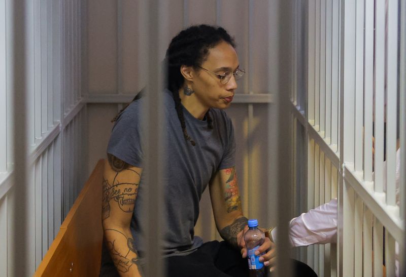 Basketball player Brittney Griner, who was detained at Moscow's Sheremetyevo airport and later charged with illegal possession of cannabis, sits inside a defendants' cage after the court's verdict in Khimki outside Moscow on Aug. 4.