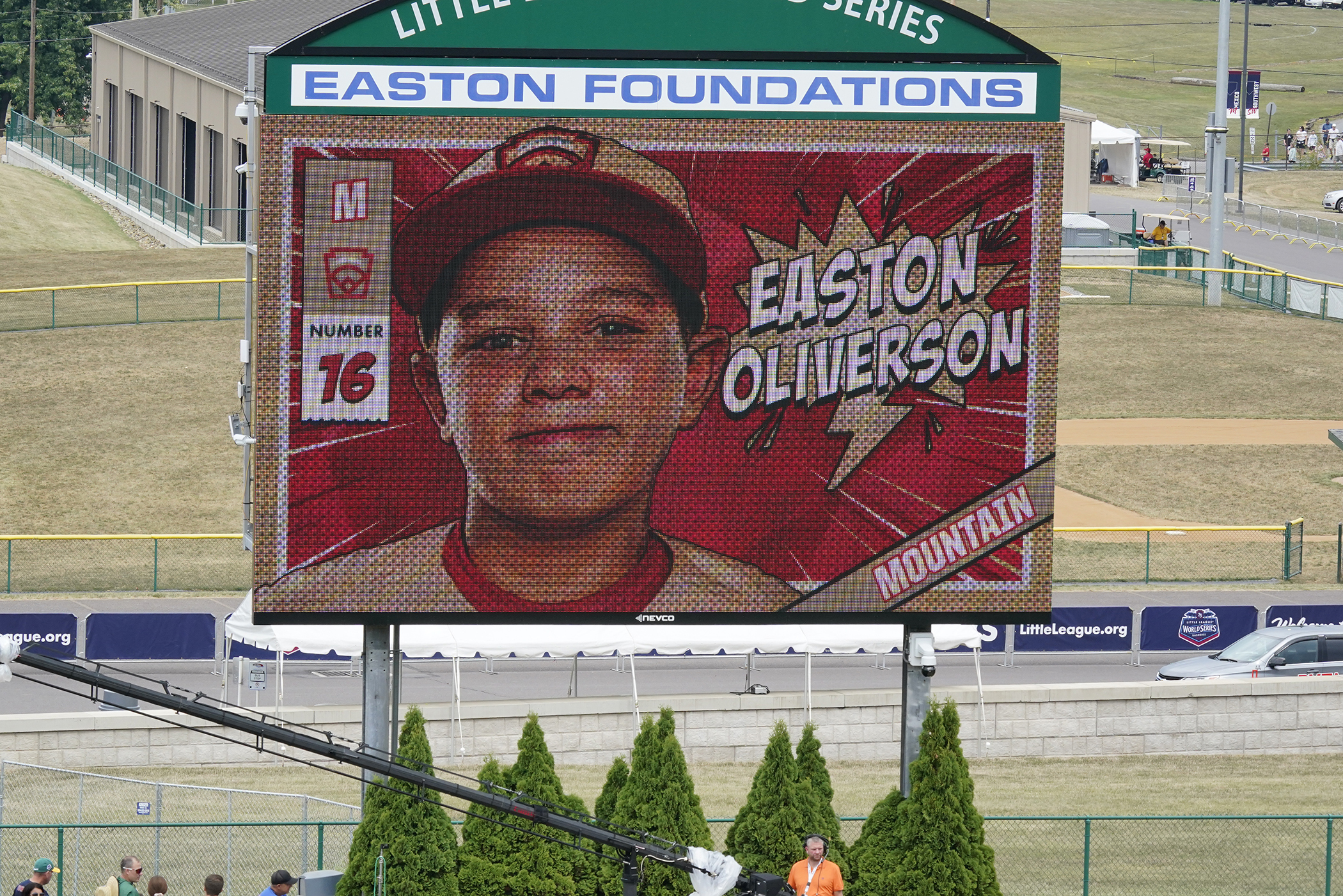 A picture of Mountain Region Champion Little League team member Easton Oliverson, from Santa Clara, Utah, is shown on the scoreboard at Volunteer Stadium during the opening ceremony of the 2022 Little League World Series baseball tournament in South Williamsport, Pa., Wednesday. Oliverson was injured when he fell out of a bunk bed at the dormitory complex. An Instagram account says that his skull cap will be put back in on Friday.