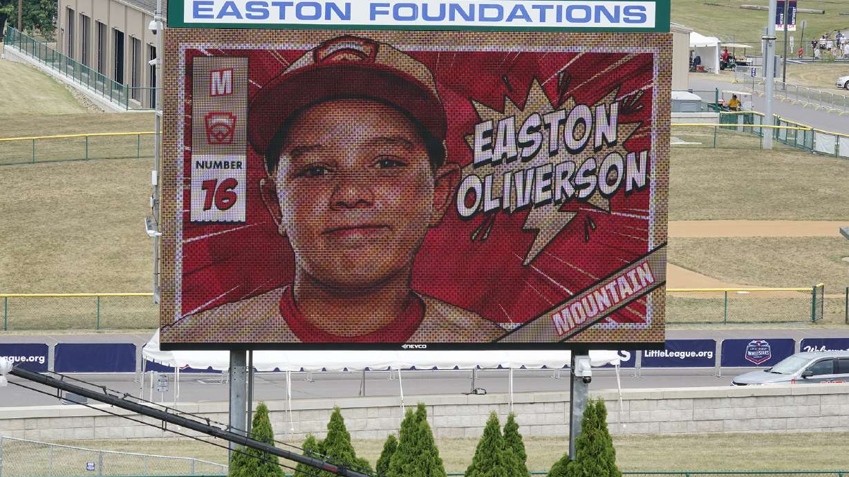 A picture of Mountain Region Champion Little League team member Easton Oliverson, from Santa Clara, Utah, is shown on the scoreboard at Volunteer Stadium during the opening ceremony of the 2022 Little League World Series baseball tournament in South Williamsport, Pa., Wednesday, Aug 17, 2022. Oliverson was injured when he fell out of a bunk bed at the dormitory complex.