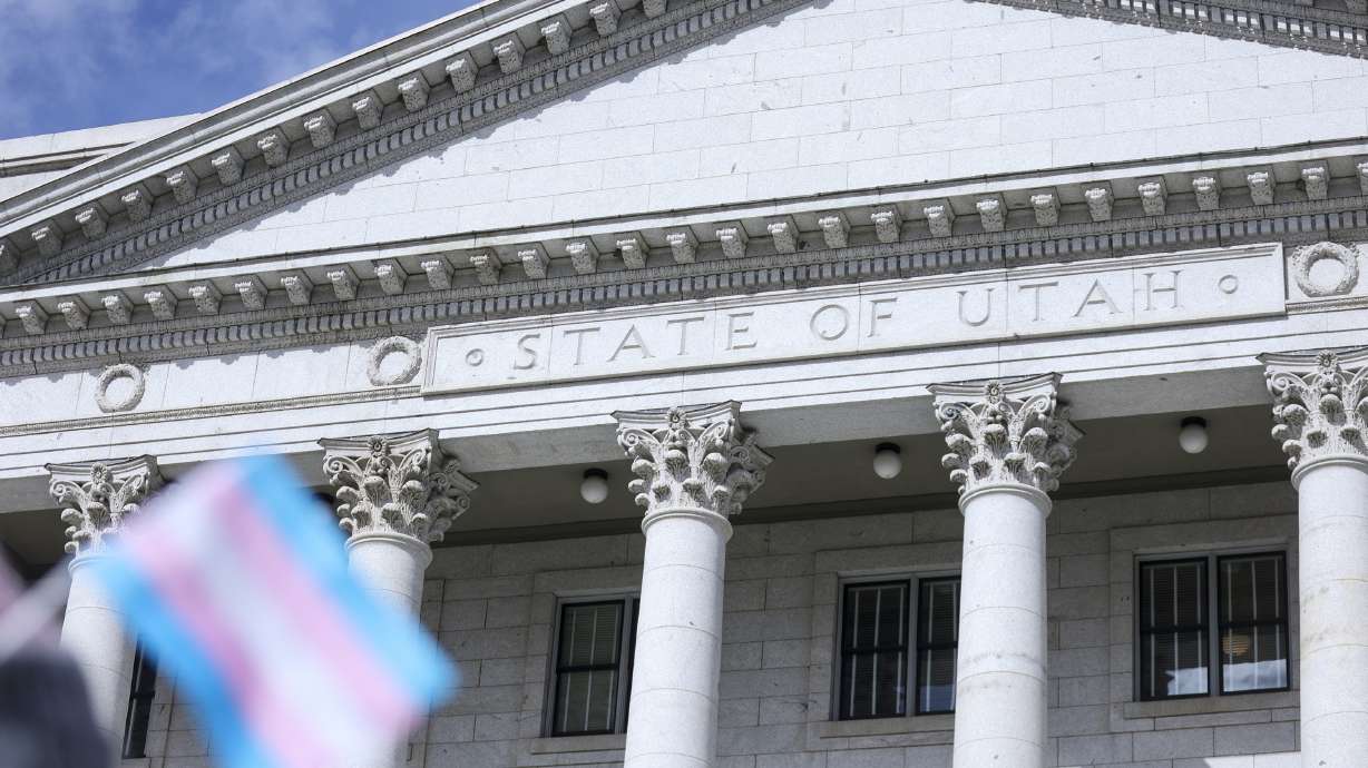 A transgender flag is pictured in front of the Capitol in Salt Lake City on Feb. 25, 2022. A House committee on Thursday approved a proposal to replace most references to "gender" in state code with "sex."