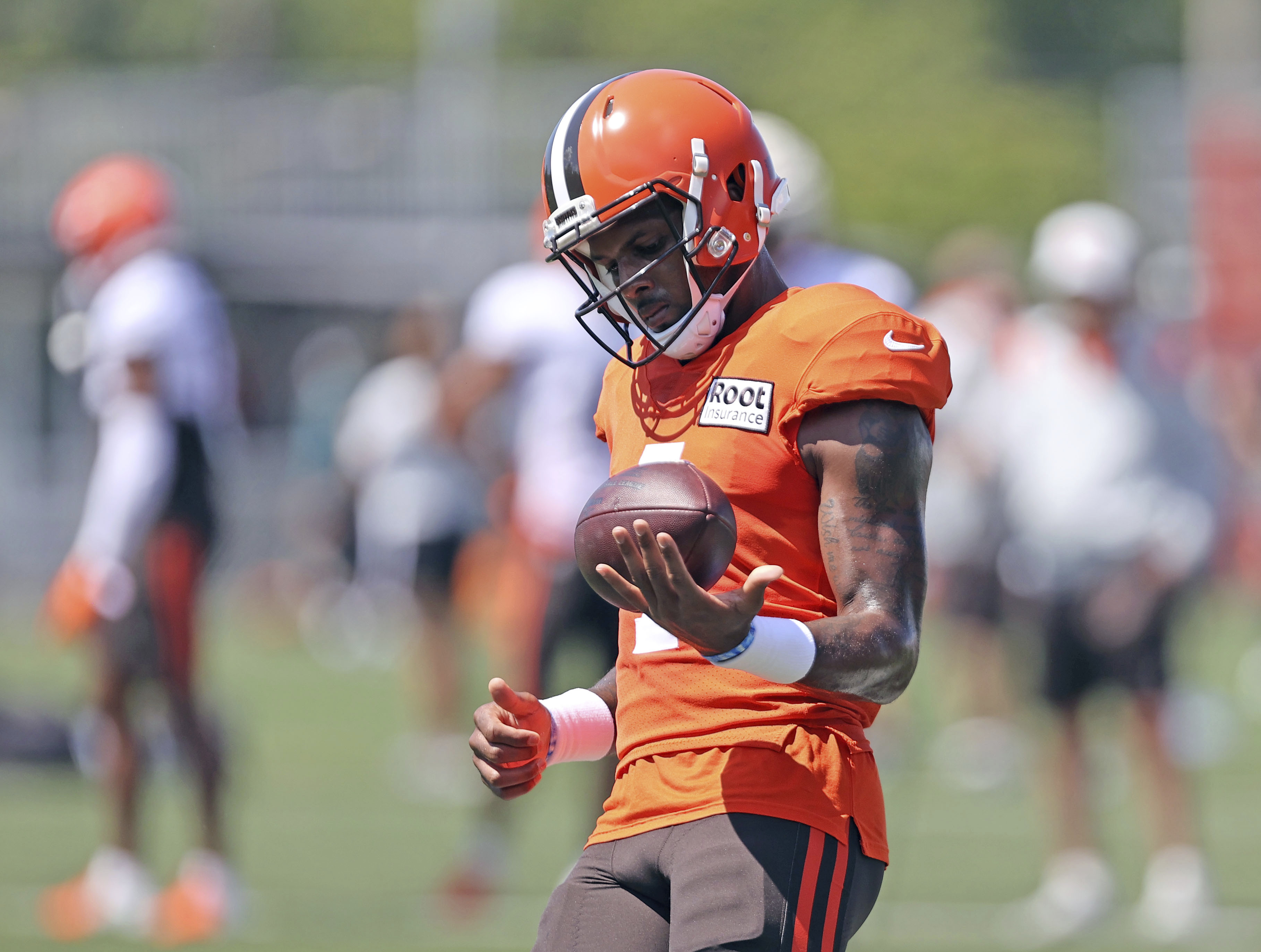 Cleveland Browns quarterback Deshaun Watson works out during a joint practice with the Philadelphia Eagles at NFL football training camp, Thursday, Aug. 18, 2022, in Berea, Ohio,. Watson has reached a settlement with the NFL and will serve an 11-game unpaid suspension and pay a $5 million fine rather than risk missing his first season as quarterback of the Cleveland Browns following accusations of sexual misconduct while he played for the Houston Texans. 