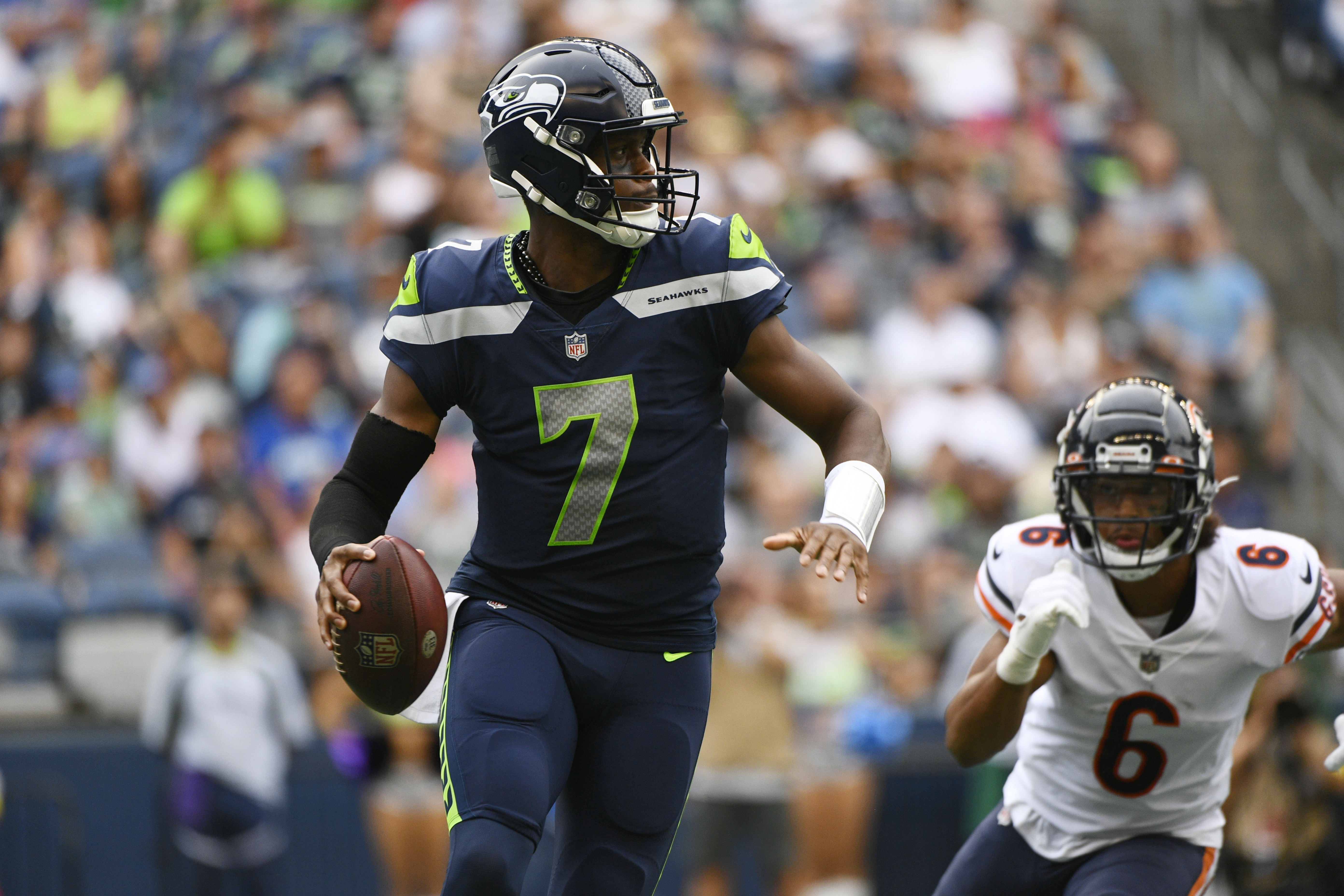 Seattle Seahawks quarterback Geno Smith (7) drops to pass as Chicago Bears' Kyler Gordon (6) closes in during the first half of a preseason NFL football game, Thursday, Aug. 18, 2022, in Seattle. 