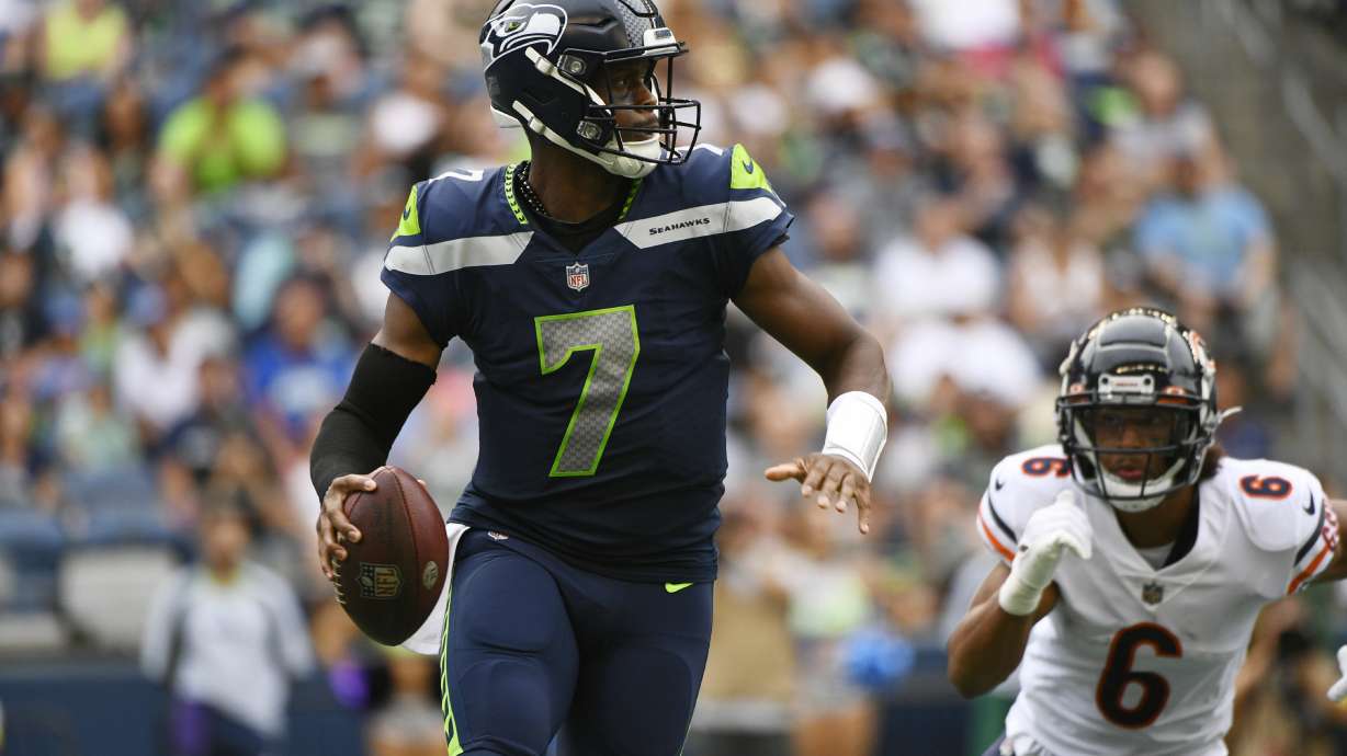 Seattle Seahawks quarterback Geno Smith (7) drops to pass as Chicago Bears' Kyler Gordon (6) closes in during the first half of a preseason NFL football game, Thursday, Aug. 18, 2022, in Seattle.