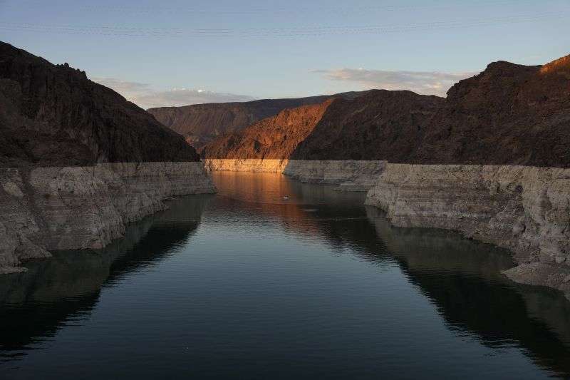 A bathtub ring of light minerals shows the high water line of Lake Mead near Hoover Dam at the Lake Mead National Recreation Area near Boulder City, Nev., on June 26. Federal officials on Tuesday, are expected to announce water cuts that would further reduce how much Colorado River water some users in the seven U.S. states reliant on the river and Mexico receive.