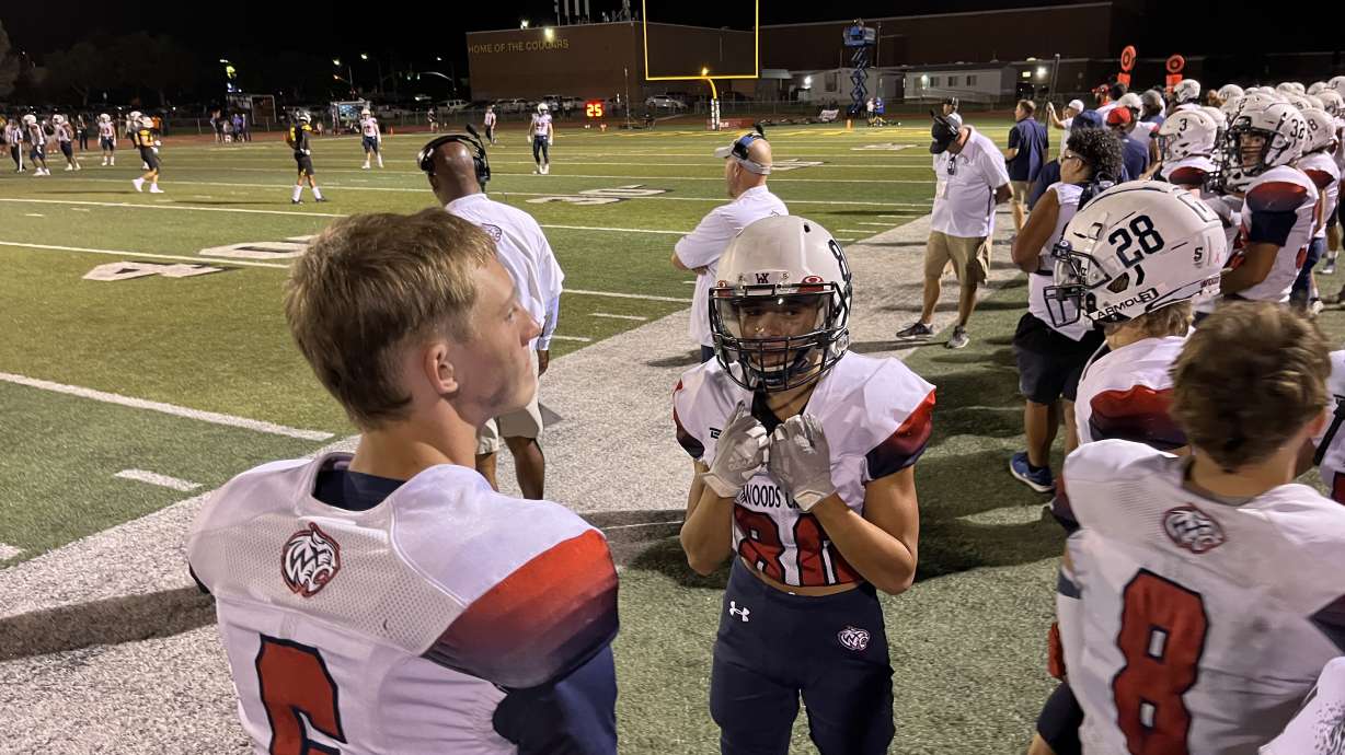 Woods Cross celebrates the Wildcats' first win under second-year coach Brody Benson, 27-13 at Kearns, Thursday, Aug. 18, 2022.