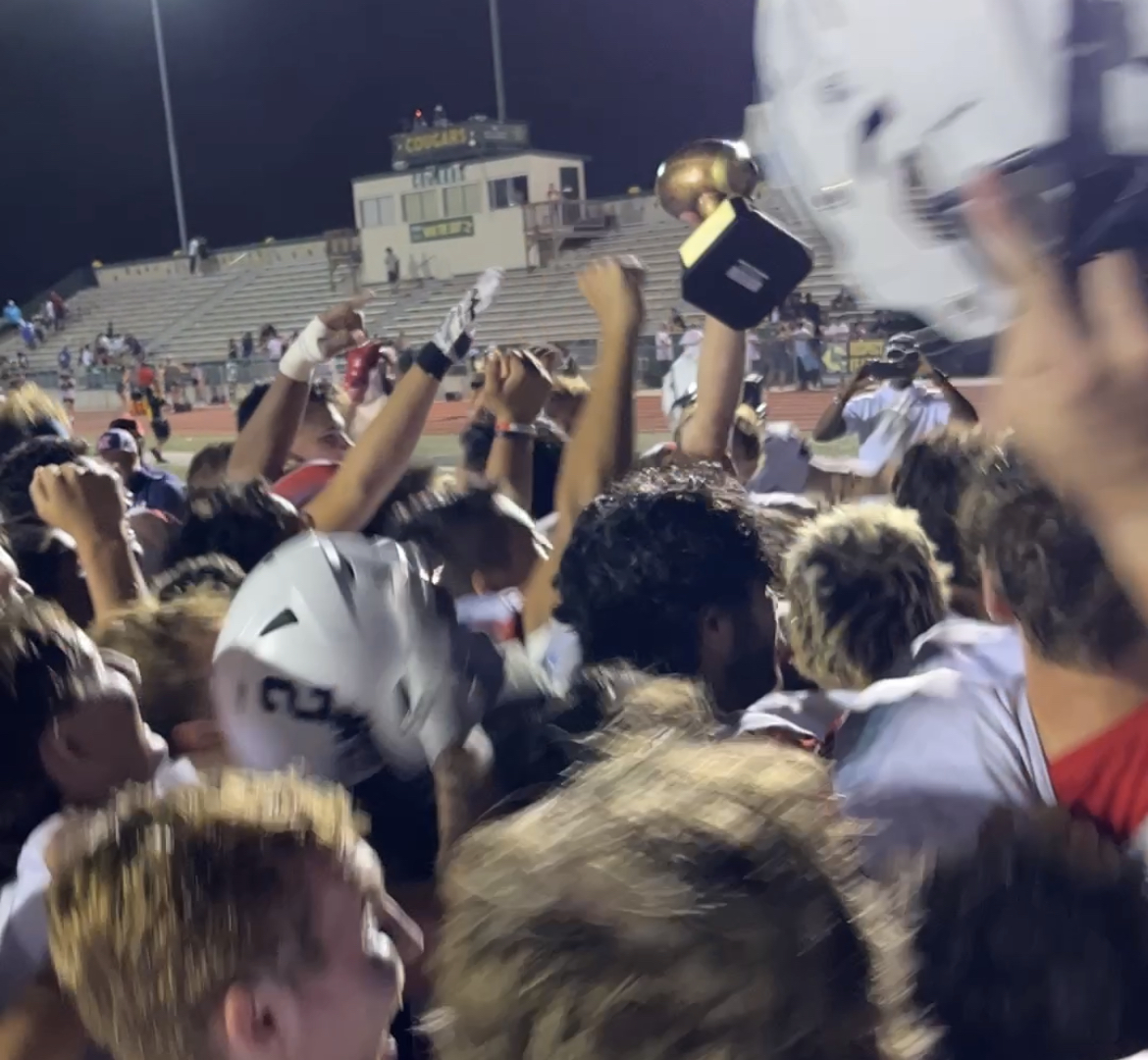 Woods Cross celebrates the Wildcats' first win under second-year coach Brody Benson, 27-13 at Kearns, Thursday, Aug. 18, 2022.