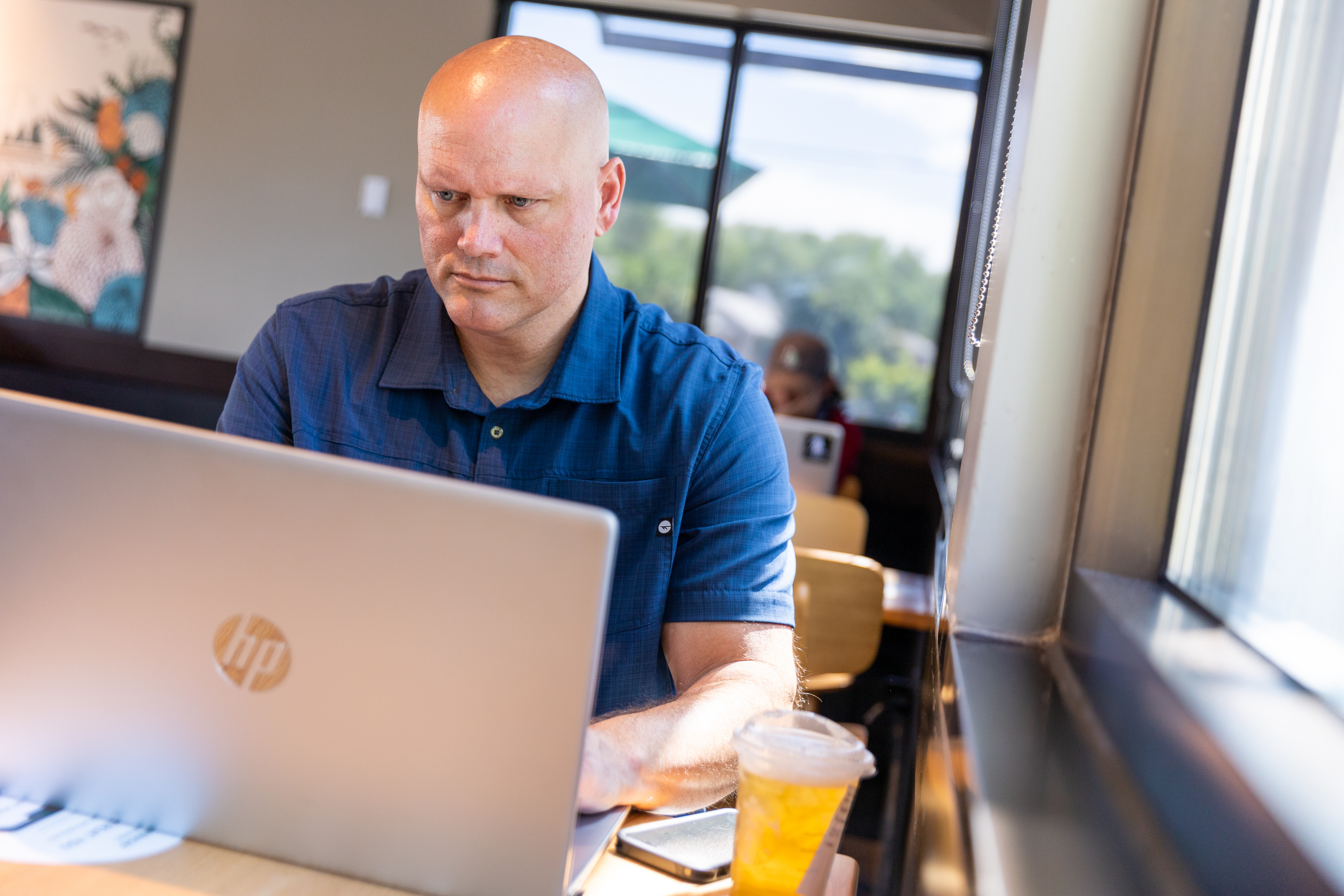 Scott Stephenson, the new head of the Utah Fraternal Order of Police, works remotely at a Starbucks in Sandy on Thursday, Aug. 11.