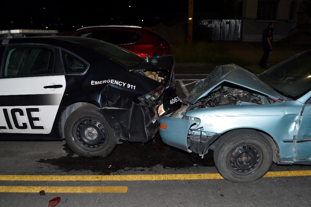A 17-year-old girl was arrested for investigation of DUI after police say she smashed into two parked police cars flashing their emergency lights early Friday. 