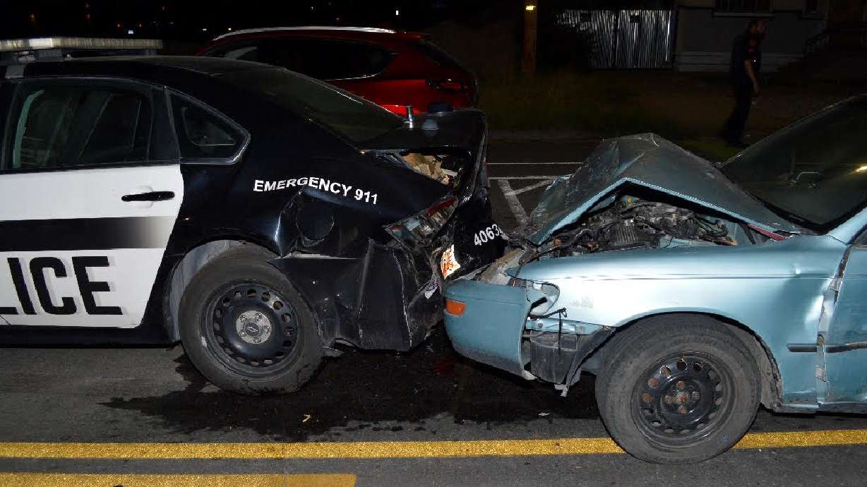 A 17-year-old girl was arrested for investigation of DUI after police say she smashed into two parked police cars flashing their emergency lights early Friday.