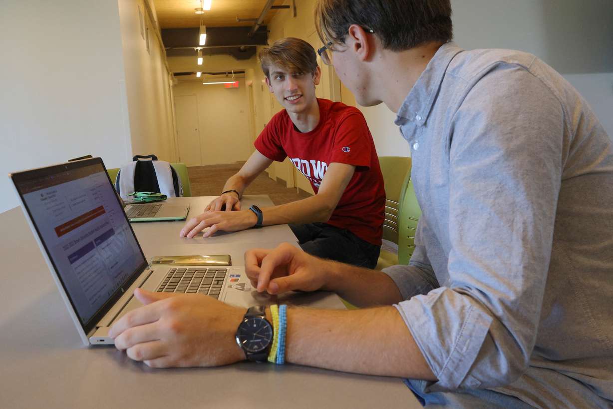 Hlib Burtsev and Oleksii Shebanov, both from Ukraine, check their email in the common area of their dorm ahead of their first year at Brown University in Providence, Rhode Island, Tuesday.