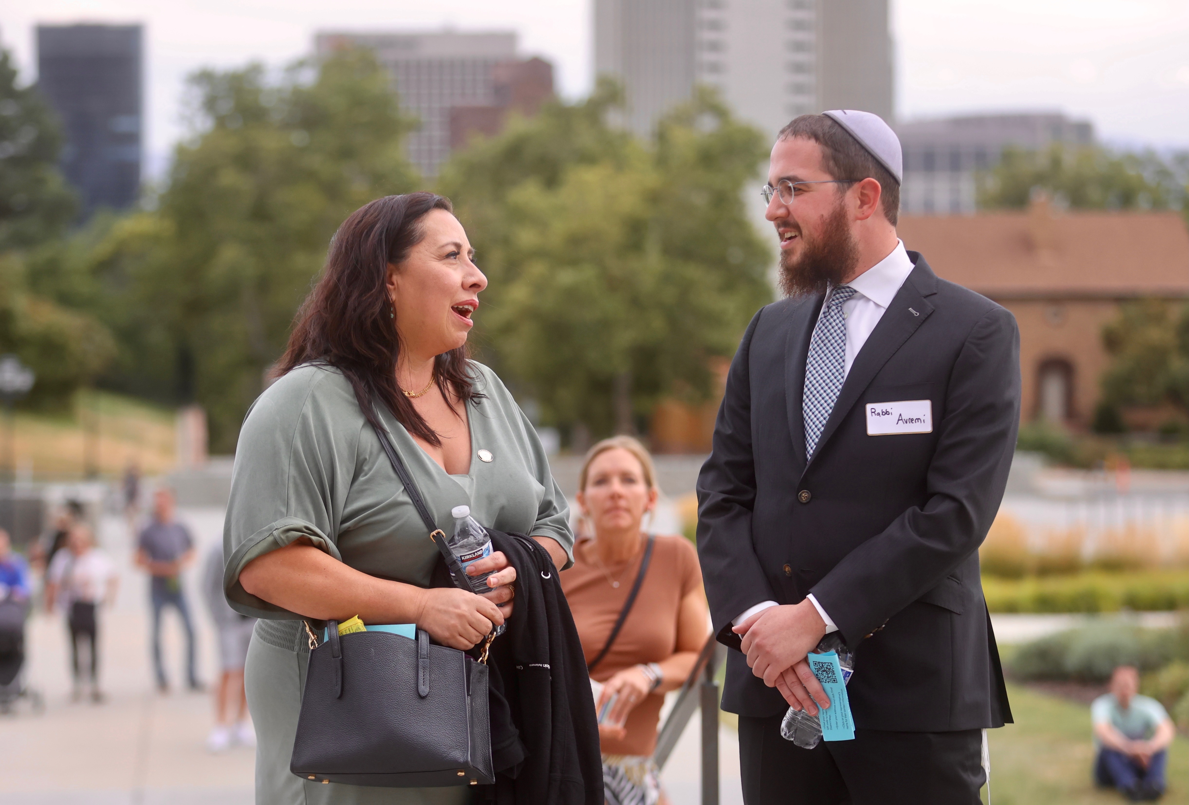 As protesters gather at the state Capitol in Salt Lake City on Friday, Rep. Angela Romero, D-Salt Lake City, talks with child sexual abuse survivor Rabbi Avremi Zippel.