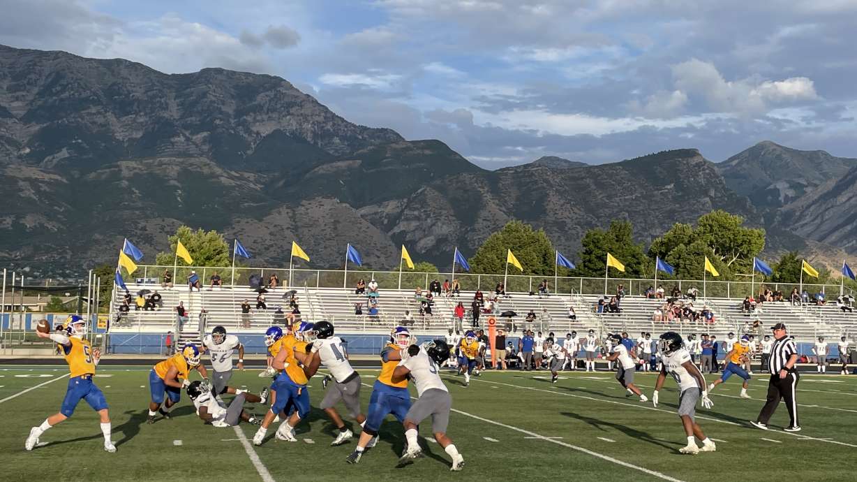 Quarterback Lance Reynolds (5) prepares to throw a pass during a game against Desert Pines (NV) High School on August 19, 2022.