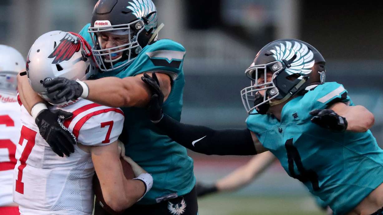 Farmington’s Ethan Briggs, center, and Luke Hansen sack Bountiful quarterback Owen Geilman during a varsity football game at Farmington High School in Farmington on Friday, Aug. 19, 2022. Farmington won 24-3.