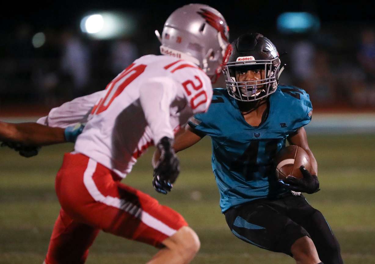 Farmington’s Lucas Peterson (41) runs with the ball past Bountiful’s Tanner Crane during a varsity football game at Farmington High School in Farmington on Friday, Aug. 19, 2022. Farmington won 24-3.