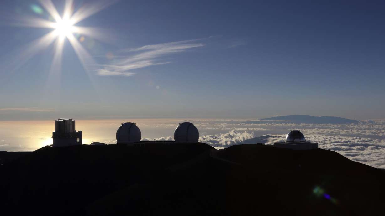 The sun sets behind telescopes on July 14, 2019, at the summit of the Big Island's Mauna Kea in Hawaii. For over 50 years, telescopes have dominated the summit of Mauna Kea, a place sacred to Native Hawaiians and one of the best places in the world to study the night sky.