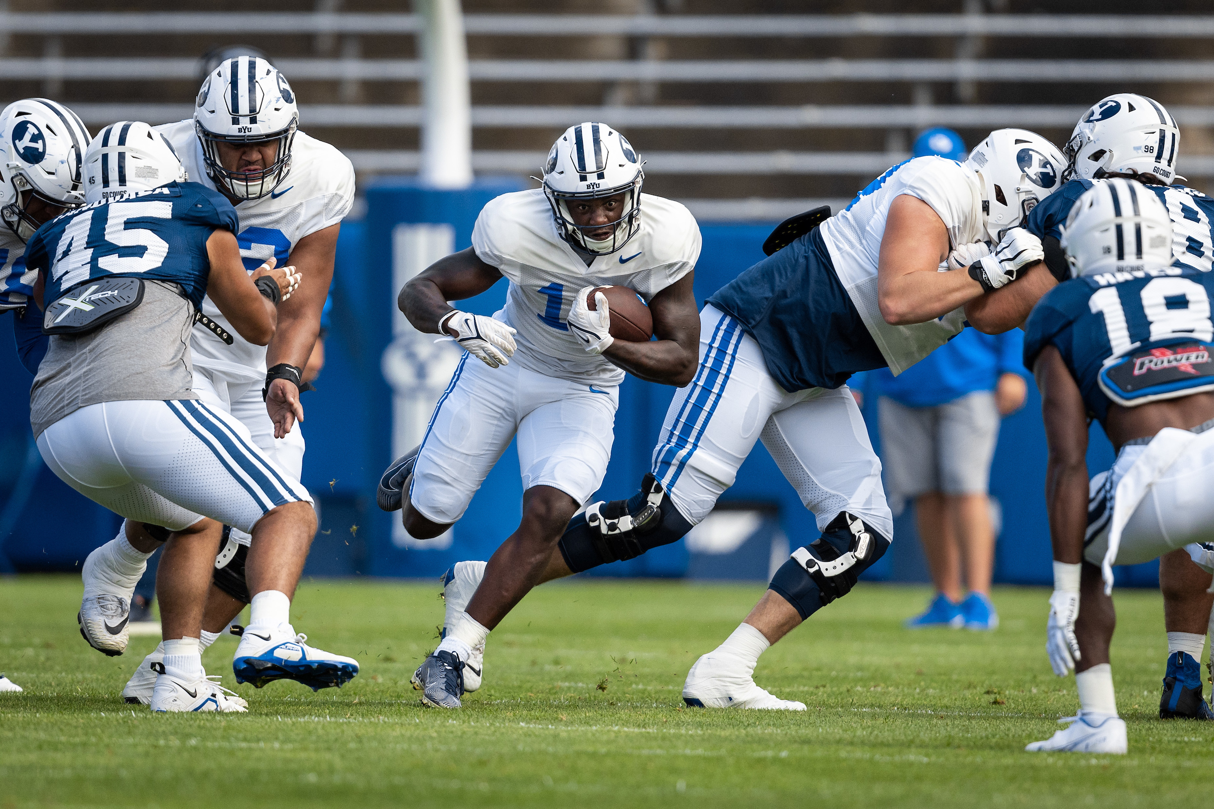 BYU running back Miles Davis runs through a hole during a scrimmage at LaVell Edwards Stadium,
Aug. 20, 2022 in Provo.