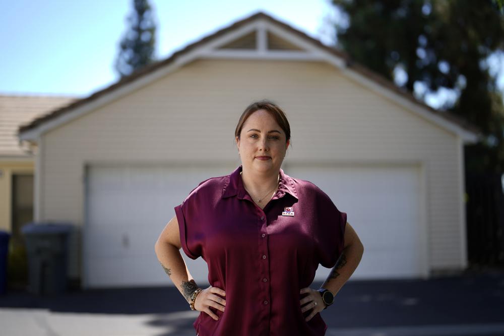 Kate Needham, a veteran who co-founded the nonprofit Armed Forces Housing Advocates, looks on in a housing complex, Tuesday in San Diego. Needham's group supplies microgrants to military families in need, some of whom have resorted to food banks because their salaries do not cover such basics.